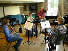 [Image: Trio rehearsing]